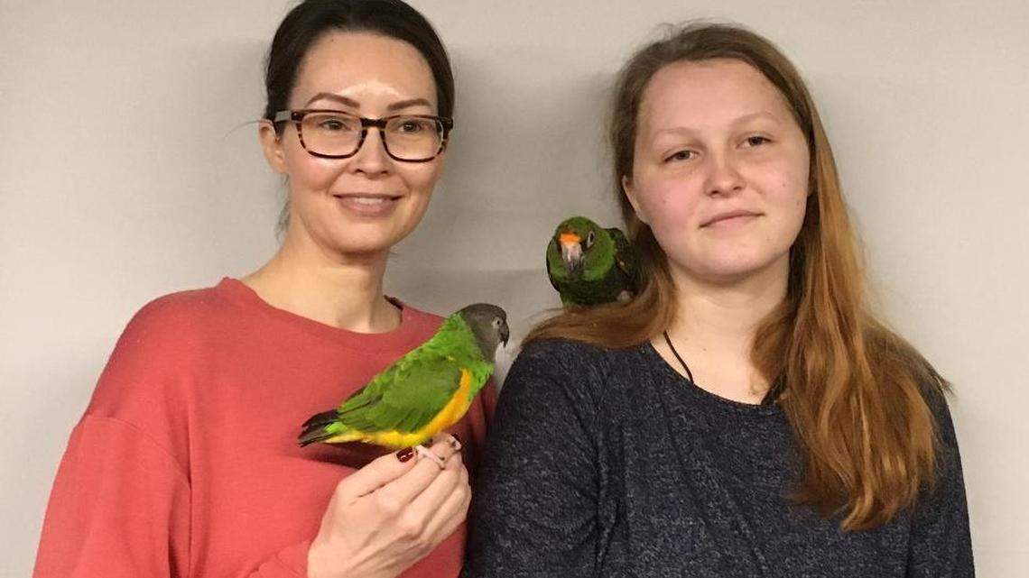 Nicole Whelan and her daughter, Ellie, are volunteers with Beak n Wings. They are shown here with their parrots, Bernie and Bruno.