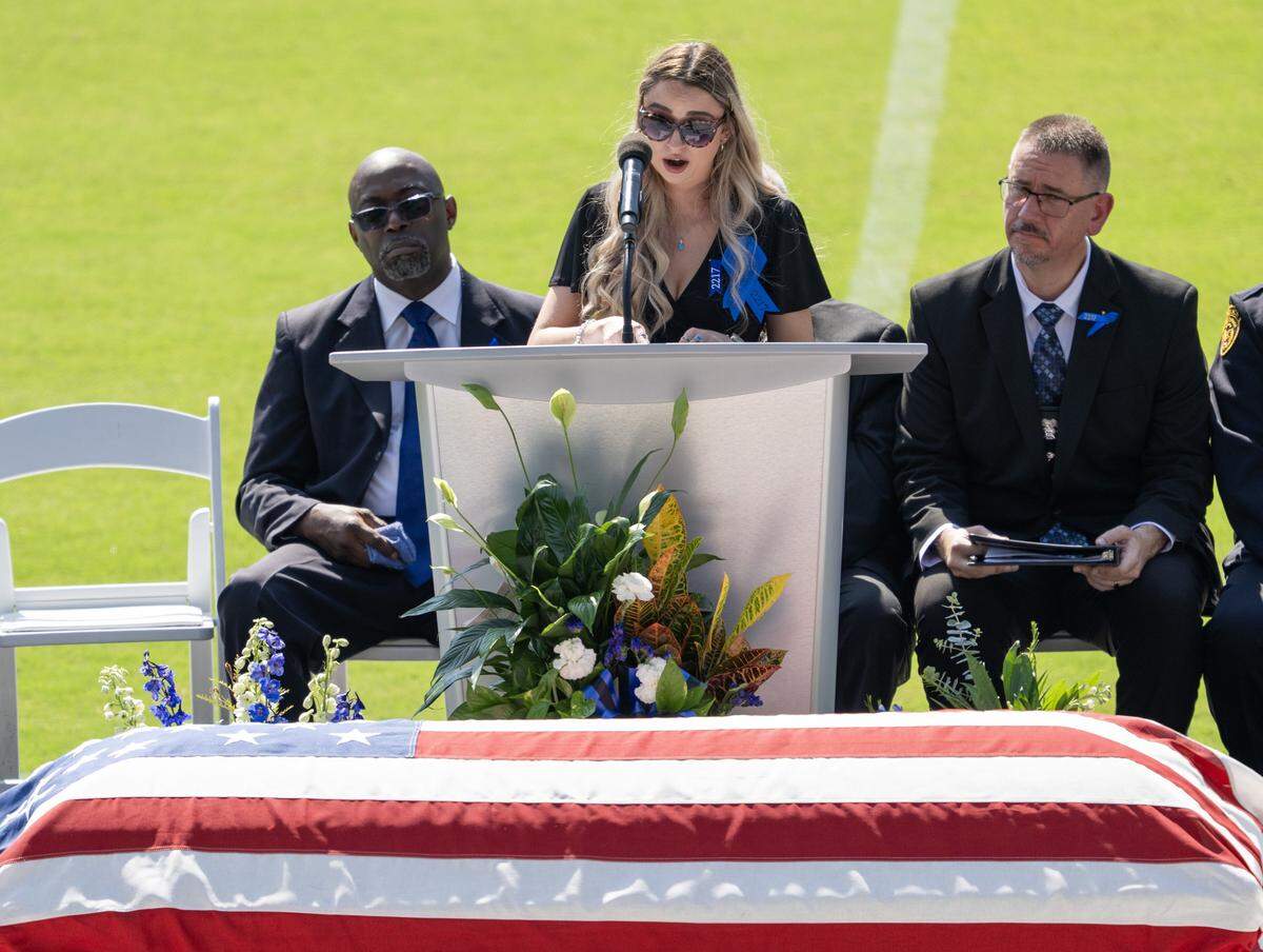 Sarah Latham, a close friend of Officer Hunter Simoncic, speaks during the readings of memories at his memorial service at Children's Mercy Park on Wednesday, Sept. 3, 2025, in Kansas City, Kansas. Simoncic was killed Aug. 26 after being struck by a fleeing driver while deploying stop sticks.