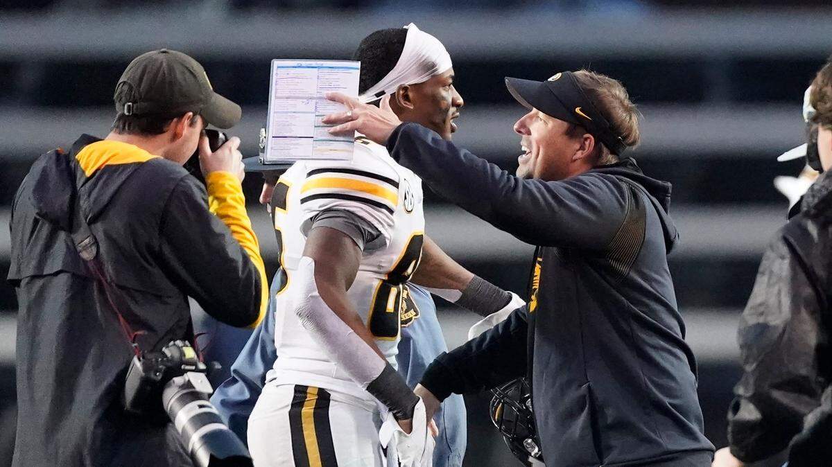 Missouri head coach Eliah Drinkwitz celebrates with wide receiver Tauskie Dove (86) after Missouri beat Vanderbilt 37-28 in an NCAA college football game Saturday, Oct. 30, 2021, in Nashville, Tenn. (AP Photo/Mark Humphrey)