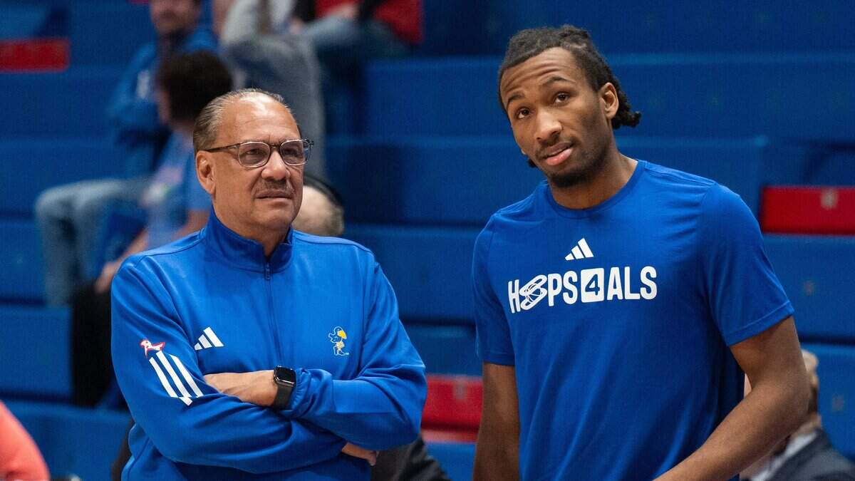 Kansas Jayhawks guard Darryn Peterson (22) talks with assistant coach Kurtis Townsend prior to the game vs. the UConn Huskies on Tuesday, December 2, 2025, at Allen Fieldhouse.
