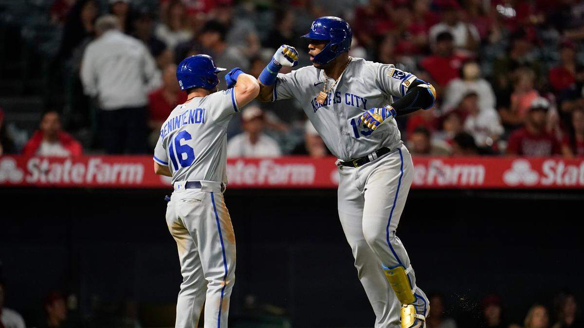 Kansas City Royals’ Salvador Perez (13) runs celebrates with Andrew Benintendi (16) after hitting a home run during the eighth inning of a baseball game against the Los Angeles Angels in Anaheim, Calif., Monday, June 20, 2022. Benintendi also scored. (AP Photo/Ashley Landis)