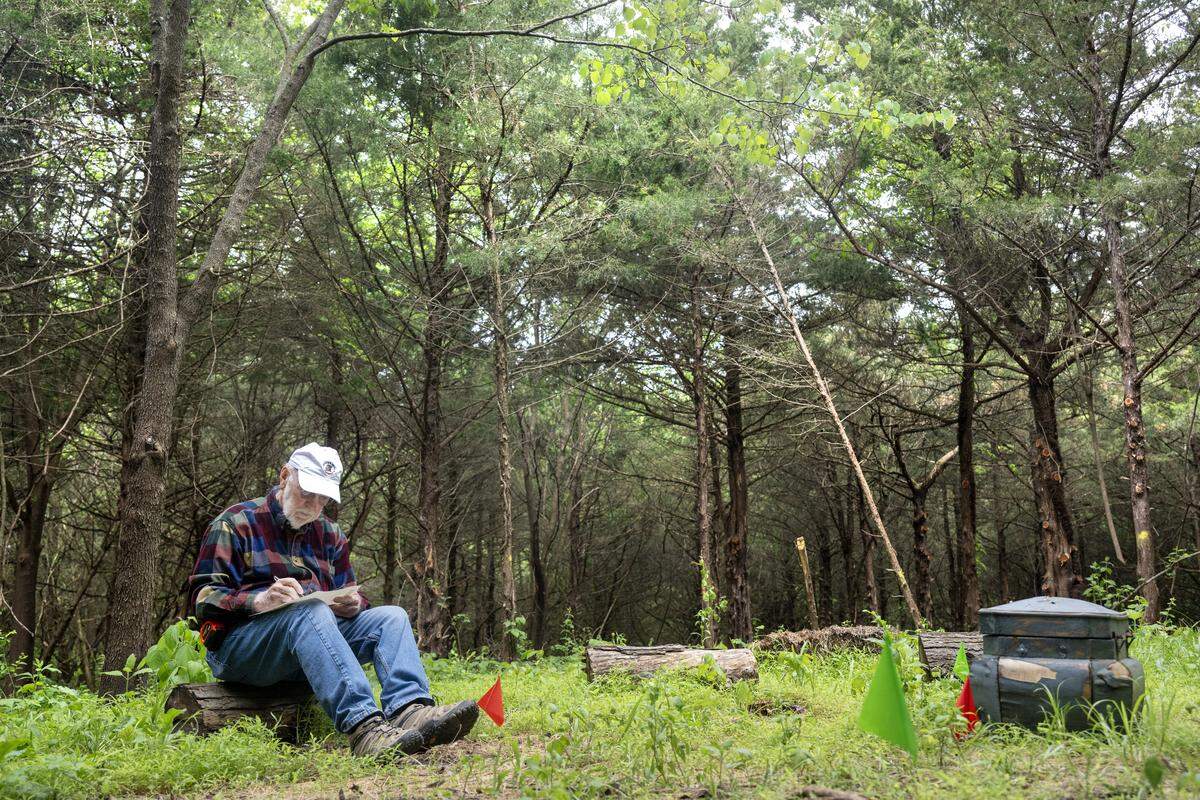Bob Berkebile, the Kansas City-based architect behind the Heart Forest project, writes a "heart wish" which will be deposited in the wish box, right, in the center of the eight-acre heart-shaped forest on Wednesday, May 6, 2026, in Kansas City.