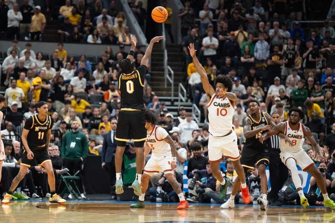 Missouri guard Anthony Robinson II (0) makes a 3-pointer over Miami guard Tru Washington (10) during the first half of the Tigers’ first-round NCAA Tournament loss to the Hurricanes at the Enterprise Center in St. Louis on Friday, March 20, 2026.