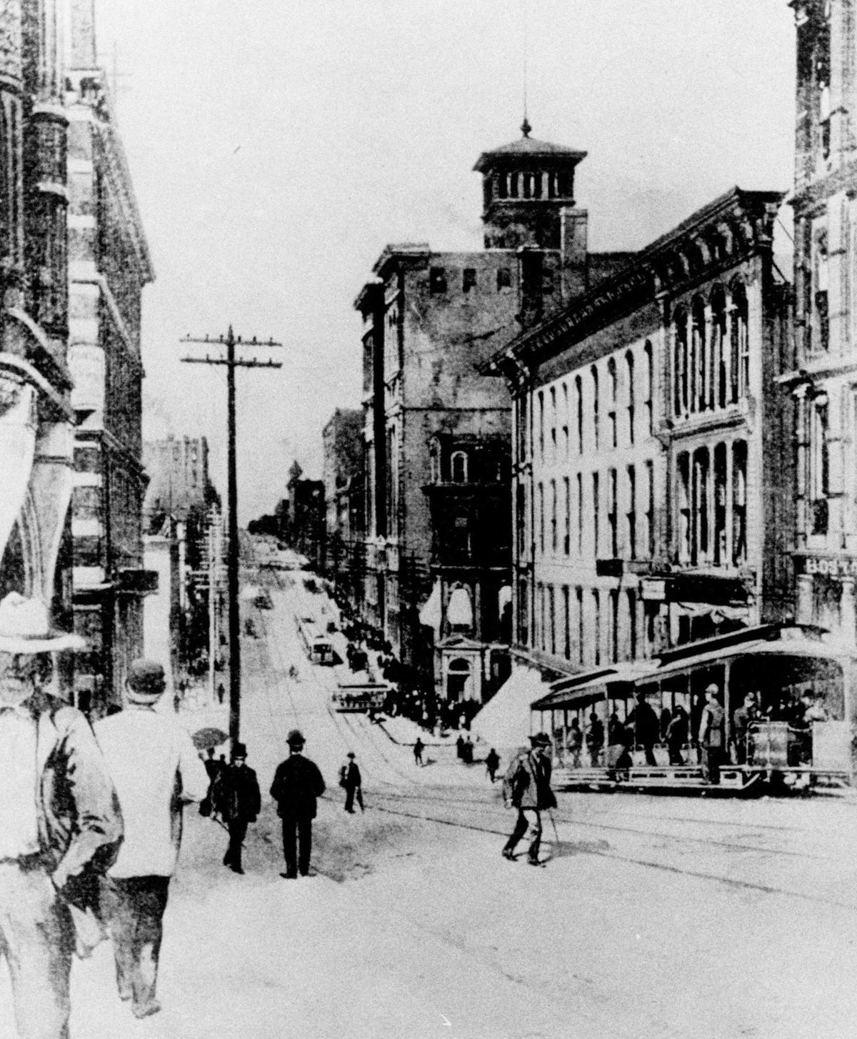 Looking west on 9th Sreet. near Walnut in 1890, a cable car and trailer. It traveled to the sleep bluff overlooking the West Bottoms and went almost straight down the face of the bluff to the old Union Depot.