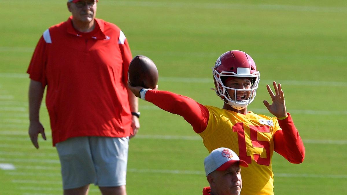Kansas City Chiefs quarterback Patrick Mahomes, drops back to pass as coach Andy Reid looks on during a drill. Training camp began Saturday for select players at Missouri Western State University in St. Joseph.