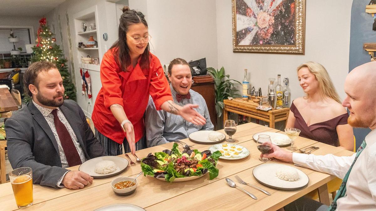 Private chef Christina Clark presents a beautifully crafted entree to guests at a dinner party she was hired to cater.