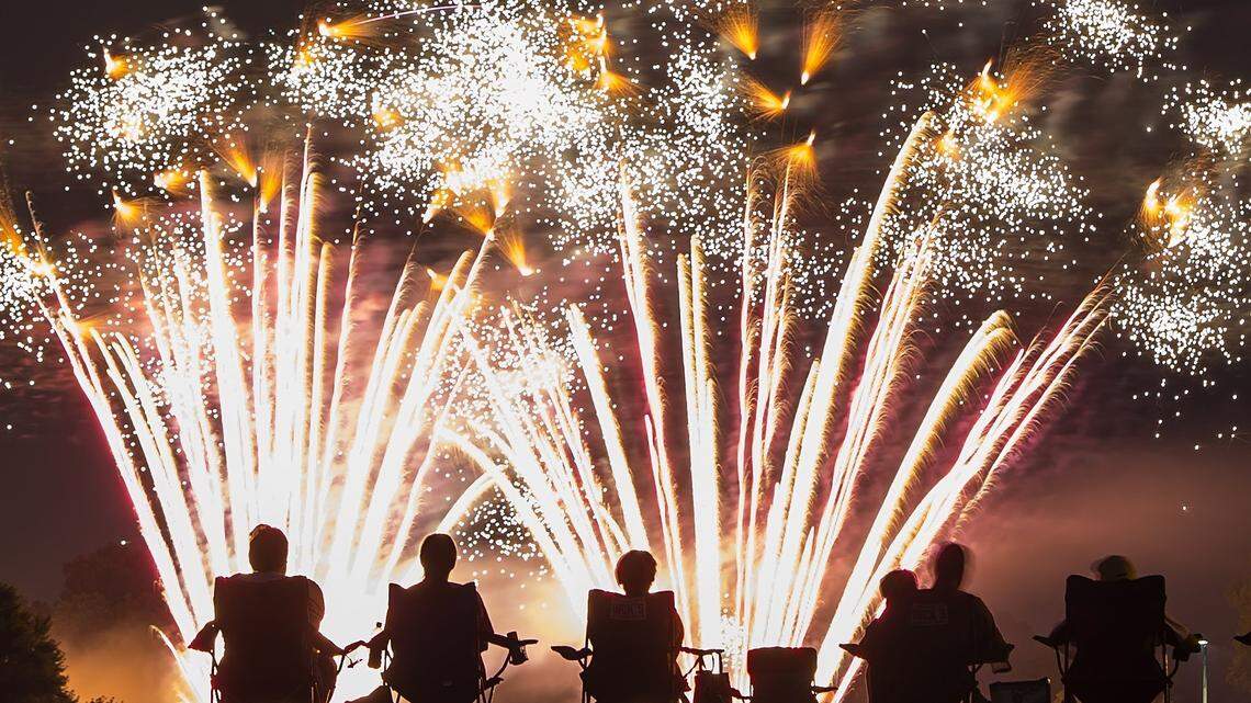 Spectators watch a previous year's fireworks display at Bishop Miege High School. The show set to take place there Wednesday has been postponed.