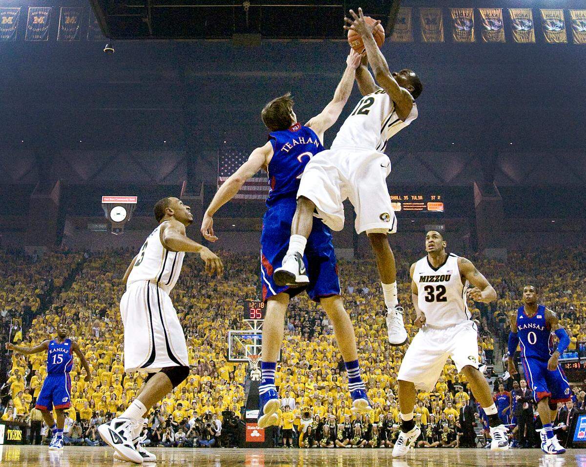 MU’s Marcus Denmon not only led all scorers with 29 points, he pulled down nine rebounds, this one over KU’s Conner Teahan during the Tigers’ 74-71 victory on Feb. 4, 2012 at Mizzou Arena in Columbia.