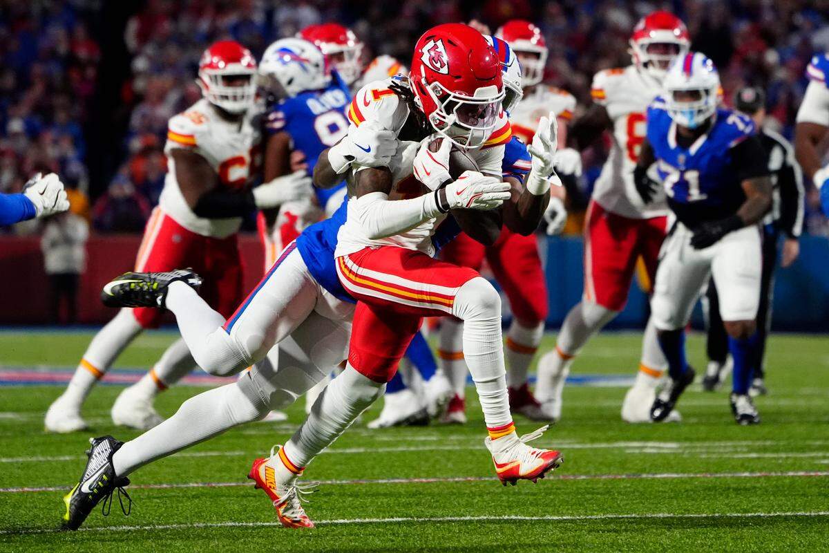 Buffalo Bills cornerback Rasul Douglas (31) tackles Kansas City Chiefs wide receiver Xavier Worthy (1) running with the ball during the first half at Highmark Stadium. 