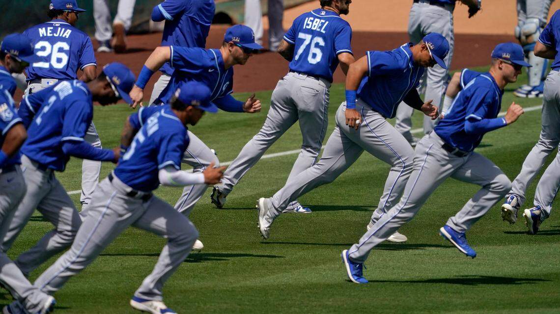The Kansas City Royals warm up prior to a spring training baseball game against the Los Angeles Angels, Wednesday, March 24, 2021, in Tempe, Ariz. (AP Photo/Matt York)
