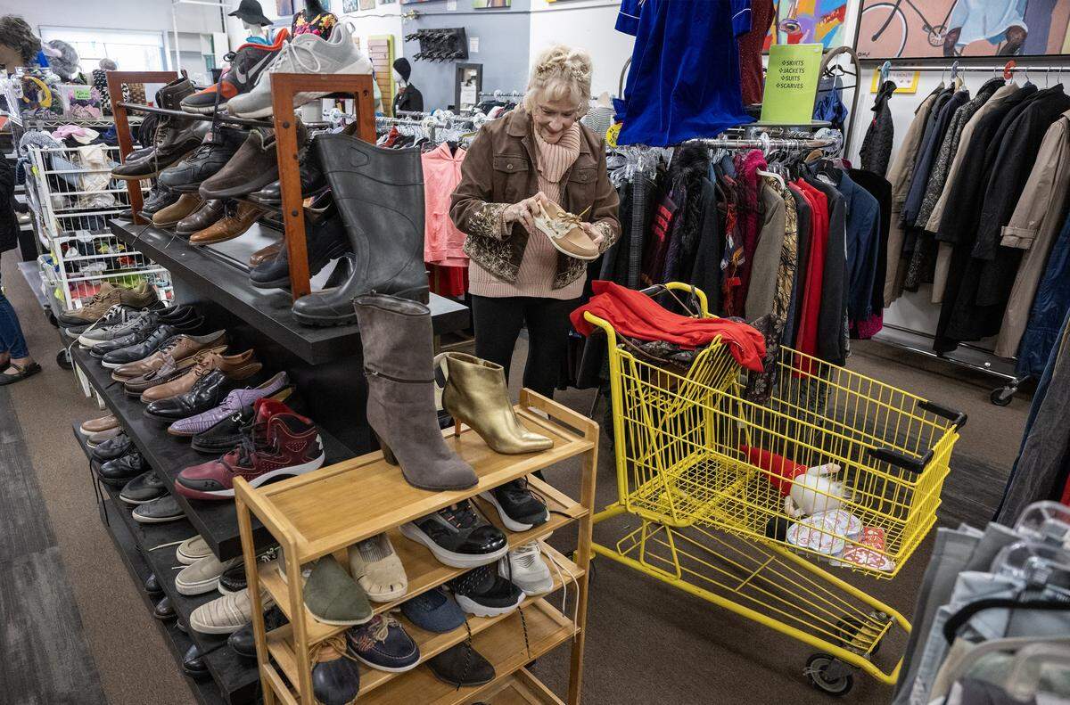 Judith Roberts of Raytown, looks over the shoes for sale at Troost39, a thrift store on Thursday, Jan. 15 2026, in Kansas City. Roberts purchased the outfit and jewelry she was wearing for $8 during a previous visit to the store.