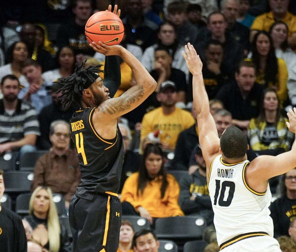 Wichita State Shockers guard Colby Rogers shoots a 3-pointer over Mizzou’s Nick Honor during Sunday afternoon’s game at Mizzou arena.