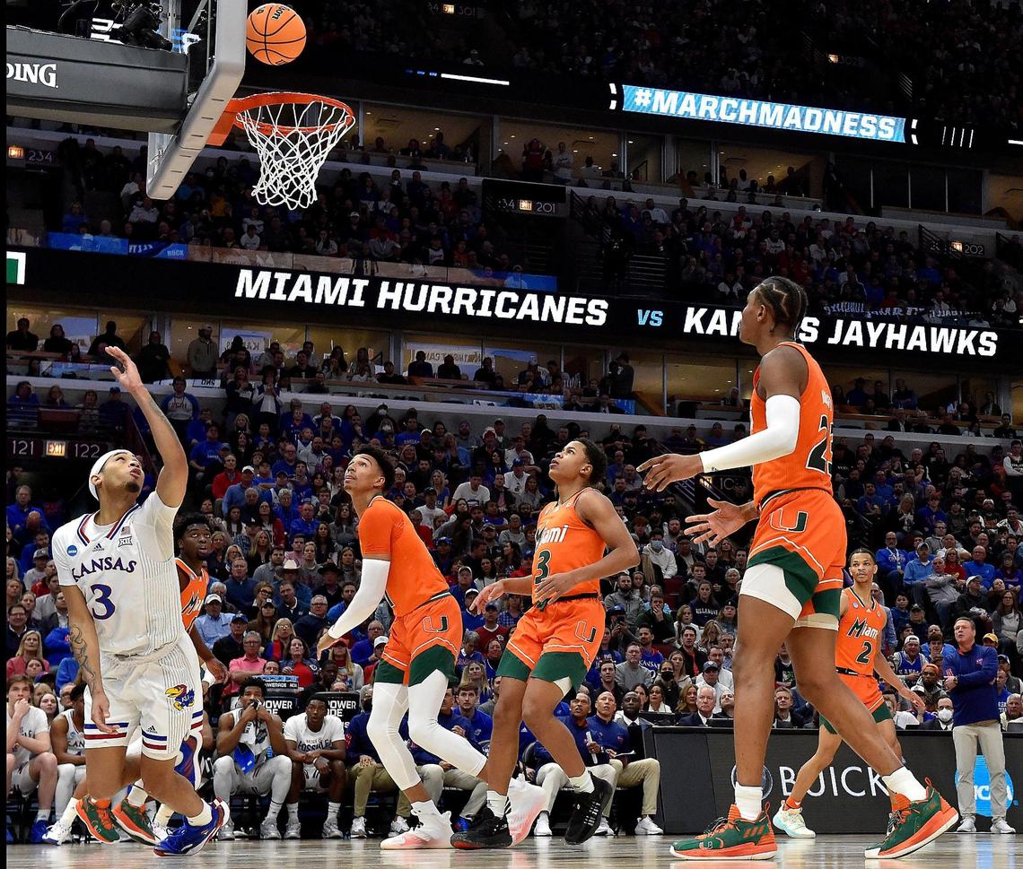 KU’s Dajuan Harris, left, managed to get this one-handed reverse layup to fall during the second half of the NCAA Midwest Regional championship game Sunday at the United Center in Chicago. KU beat Miami 76-50 to advance to the Final Four.