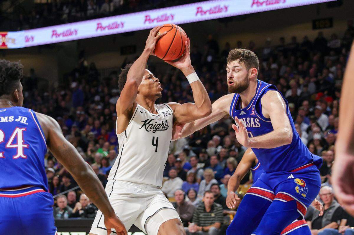 UCF Knights guard Keyshawn Hall, left, goes to the basket against Kansas Jayhawks center Hunter Dickinson during a Sunday, Jan. 5, 2025 men’s basketball game at Addition Financial Arena in Orlando.