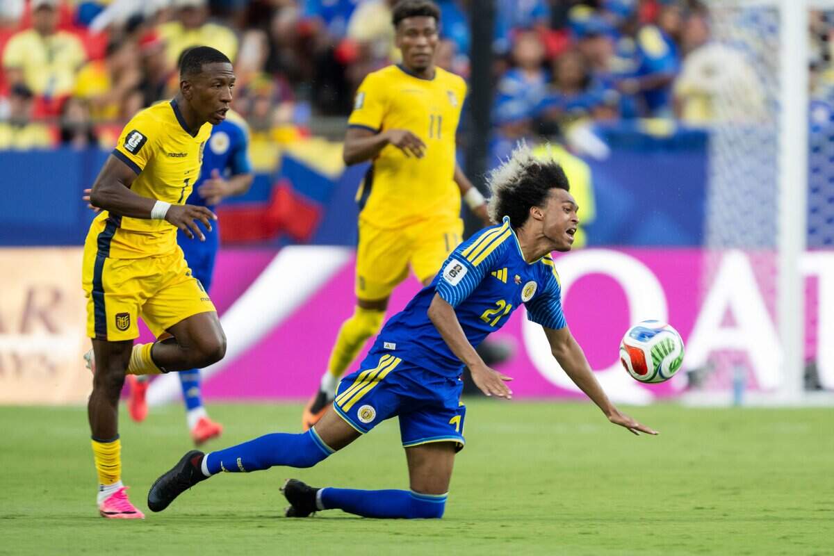 Curaçao forward Tahith Chong (21) gets fouled by a player from Ecuador in a FIFA World Cup group-stage soccer match at Kansas City (Arrowhead) Stadium in Kansas City on Saturday, June 20, 2026.