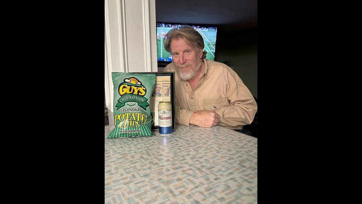 Daniel Dodson sits with the Guy’s Chips and Hamm’s beer he has during every Chiefs game.