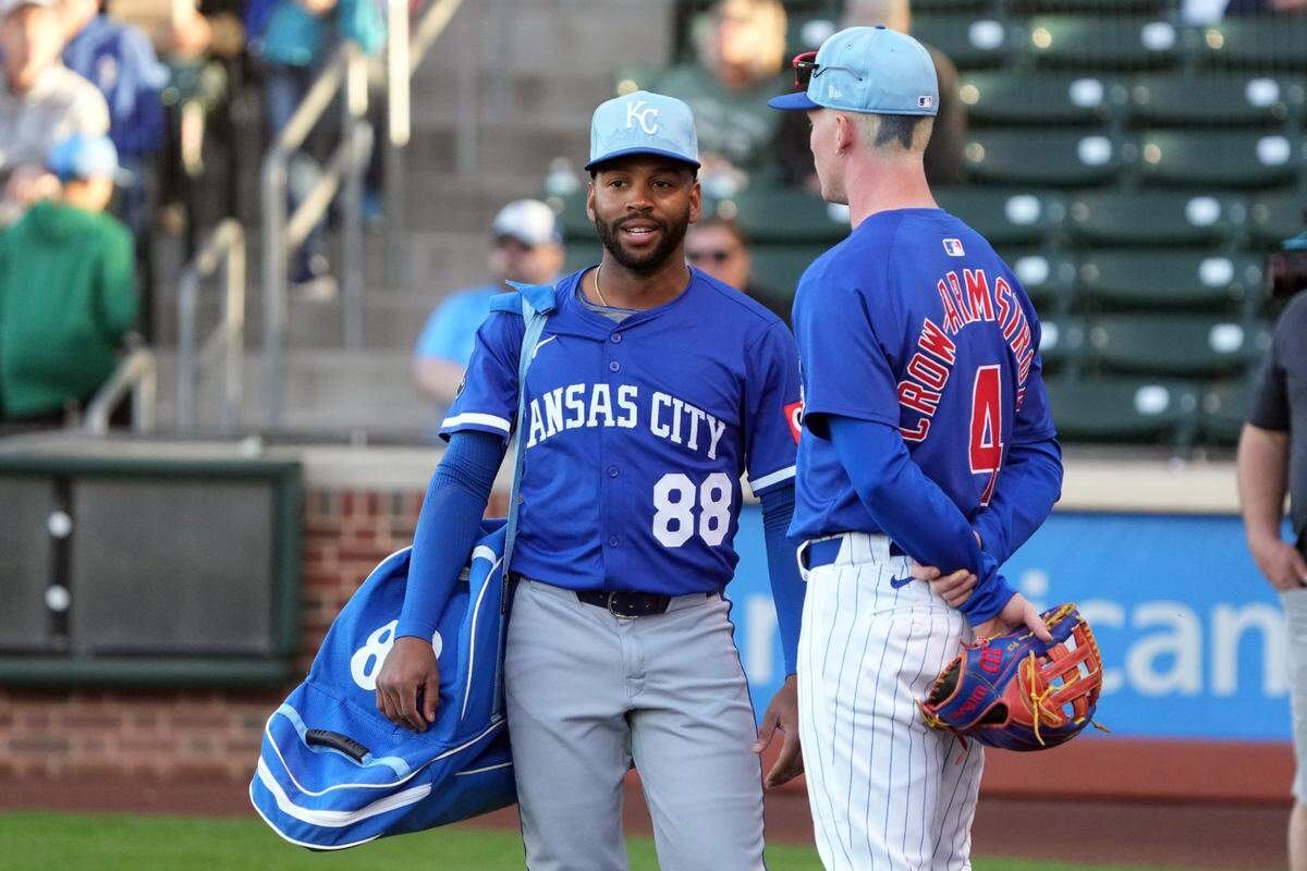 Kansas City Royals Javier Vaz and Chicago Cubs outfielder Pete Crow-Armstrong (4) talk before a game at Sloan Park on Mar 6, 2025 in Mesa, Arizona, USA.