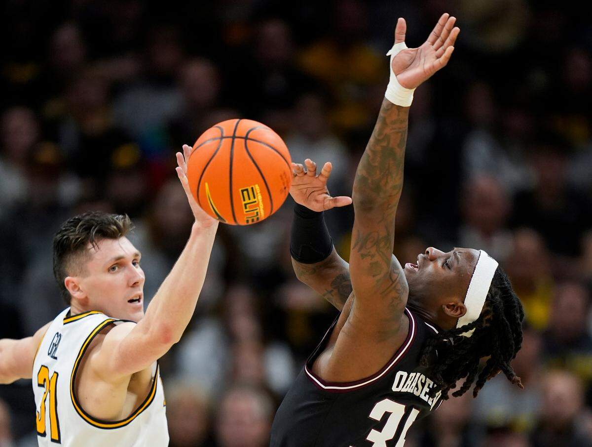 Missouri Tigers guard Caleb Grill, left, and Texas A&M Aggies guard Manny Obaseki both go for the basketball during an SEC game at Mizzou Arena in Columbia on Saturday, Feb. 8, 2025.