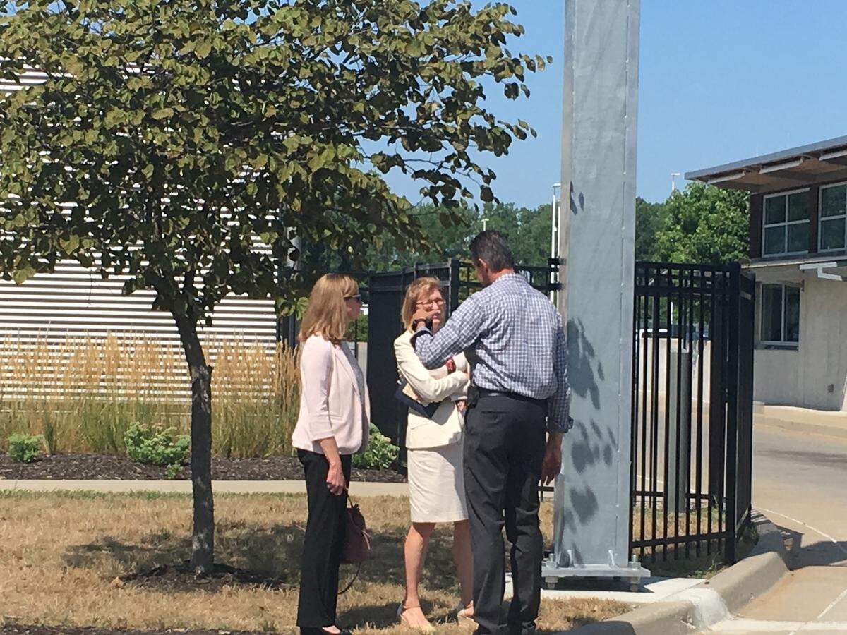 Jackson County Prosecutor Jean Peters Baker, center, spoke with police at the scene of a death investigation Thursday morning near Front Street and Interstate 435.