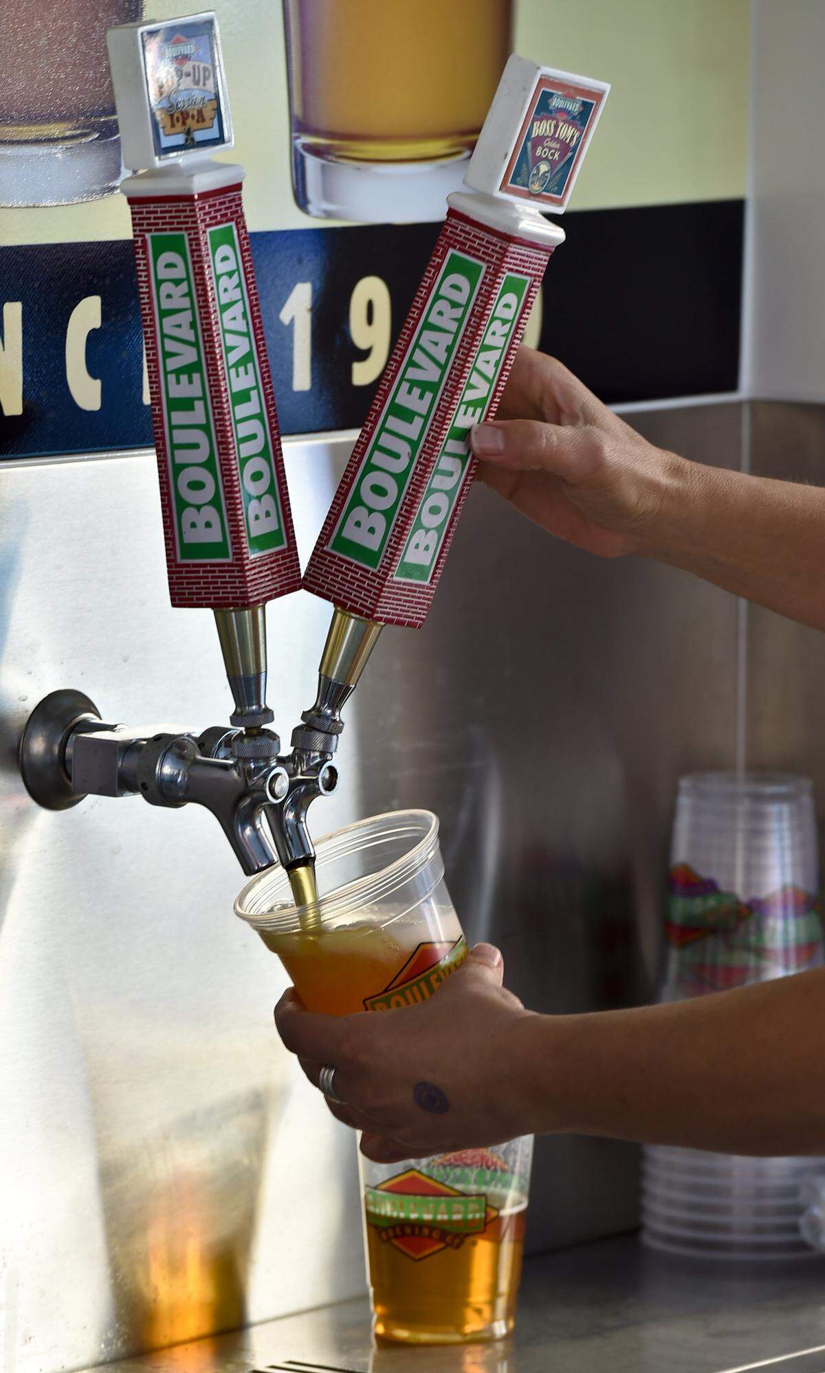 A volunteer pours beer during the Boulevardia festival in Kansas City's West Bottoms on Friday, June 13, 2014.