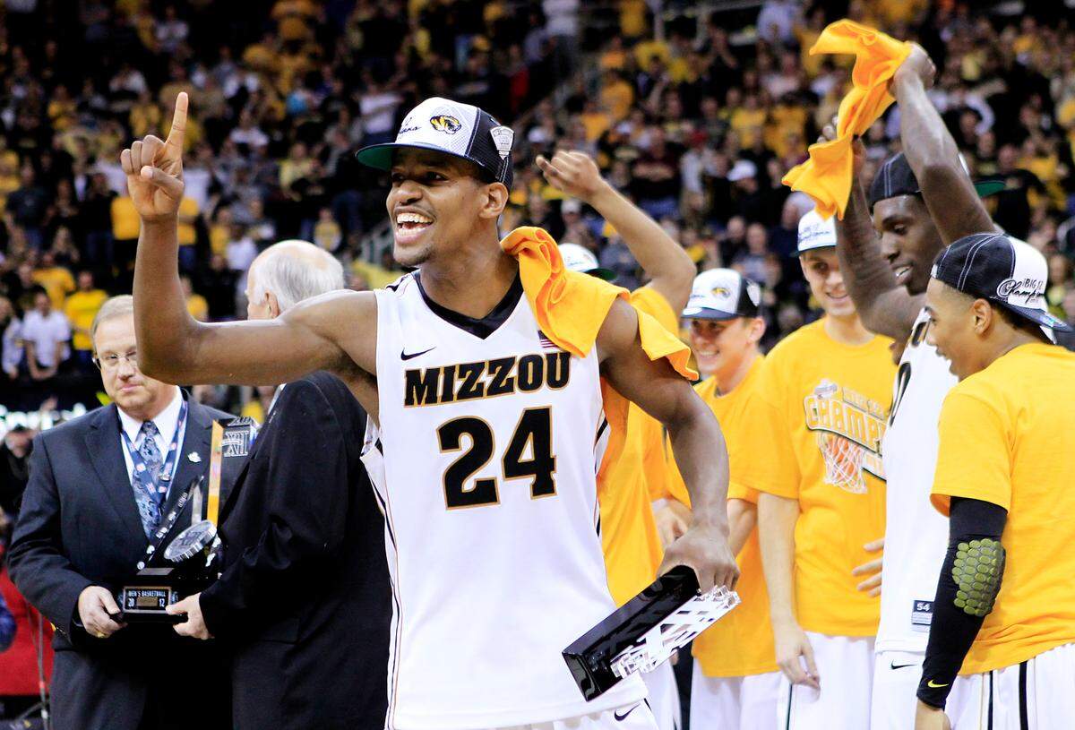With his Big 12 Tournament trophy in one hand, MU’s Kim English let everyone know the Tigers were No. 1 after they beat Baylor for the championship on March 10, 2012 at the Sprint Center in Kansas City.