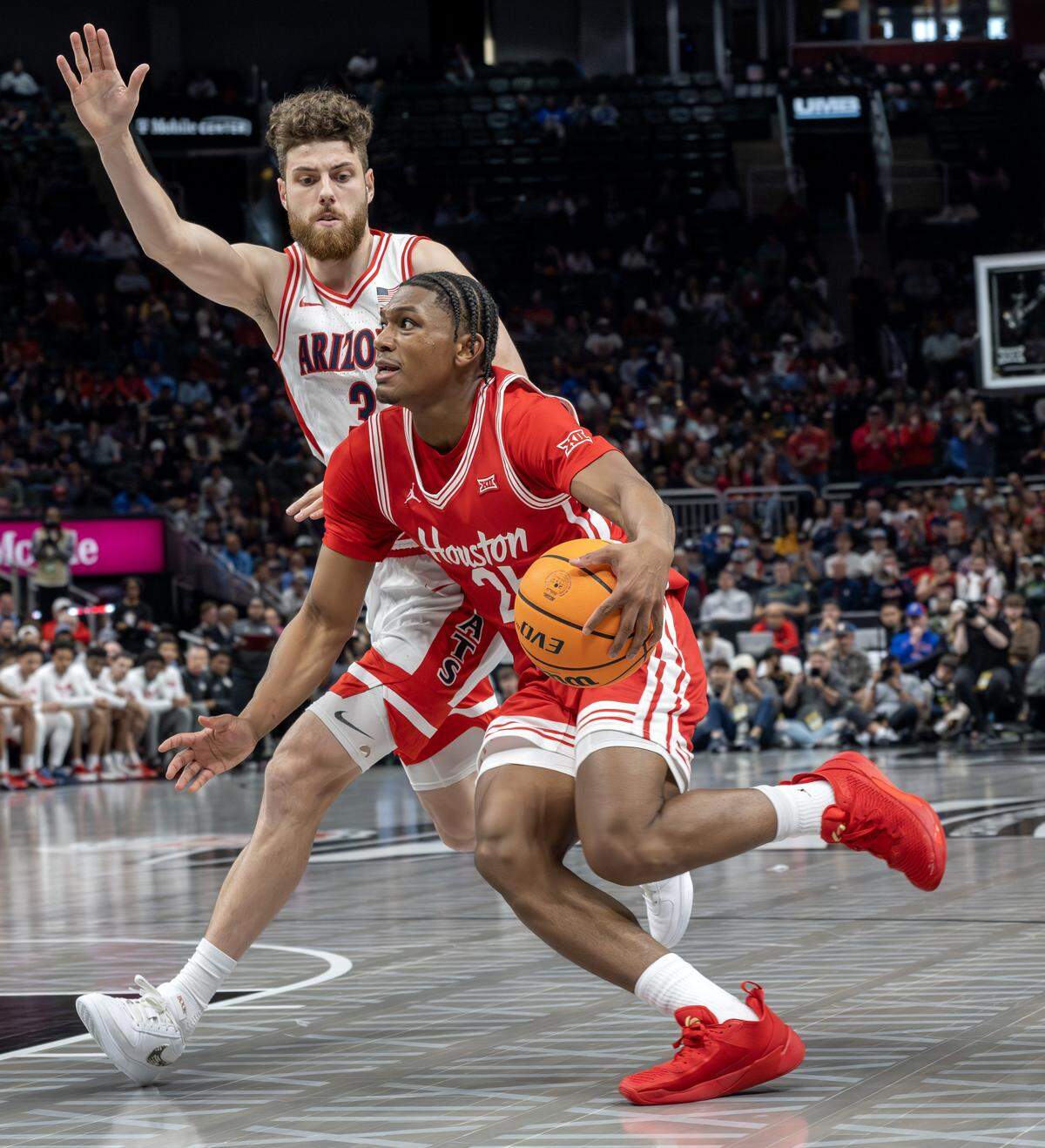 Houston Cougars guard Mercy Miller (25) shields the ball from Arizona Wildcats guard Anthony Dell'orso (3) during the first half of the Big 12 Men's Basketball Tournament Championship game at T-Mobile Center on Saturday, March 14, 2026, in Kansas City.