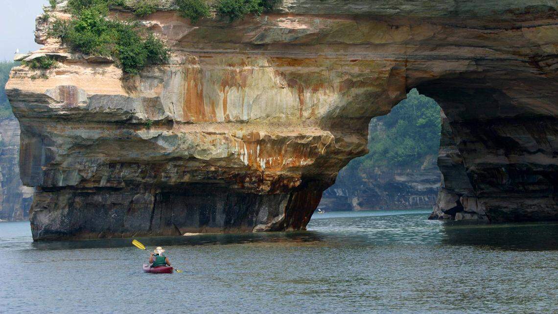 File photo of a kayaker in Lake Superior off the cliffs at Pictured Rocks National Lakeshore in 2003. Two kayakers were found dead along the shore following severe weather.