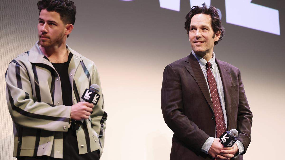 Nick Jonas and Paul Rudd speak onstage during the premiere of "Power Ballad" during SXSW at The Paramount Theatre on March 14, 2026 in Austin, Texas.