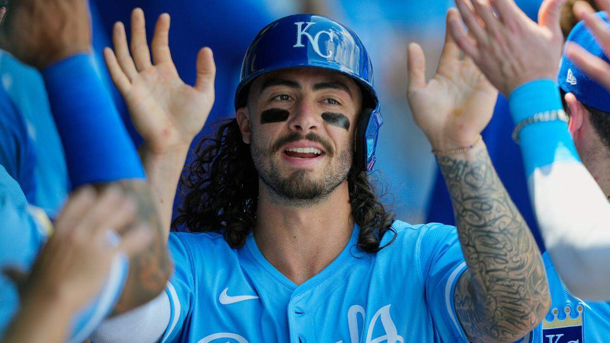 Kansas City Royals left fielder Jonathan India (6) is congratulated by teammates after scoring a run during the fifth inning against the Chicago White Sox at Kauffman Stadium.