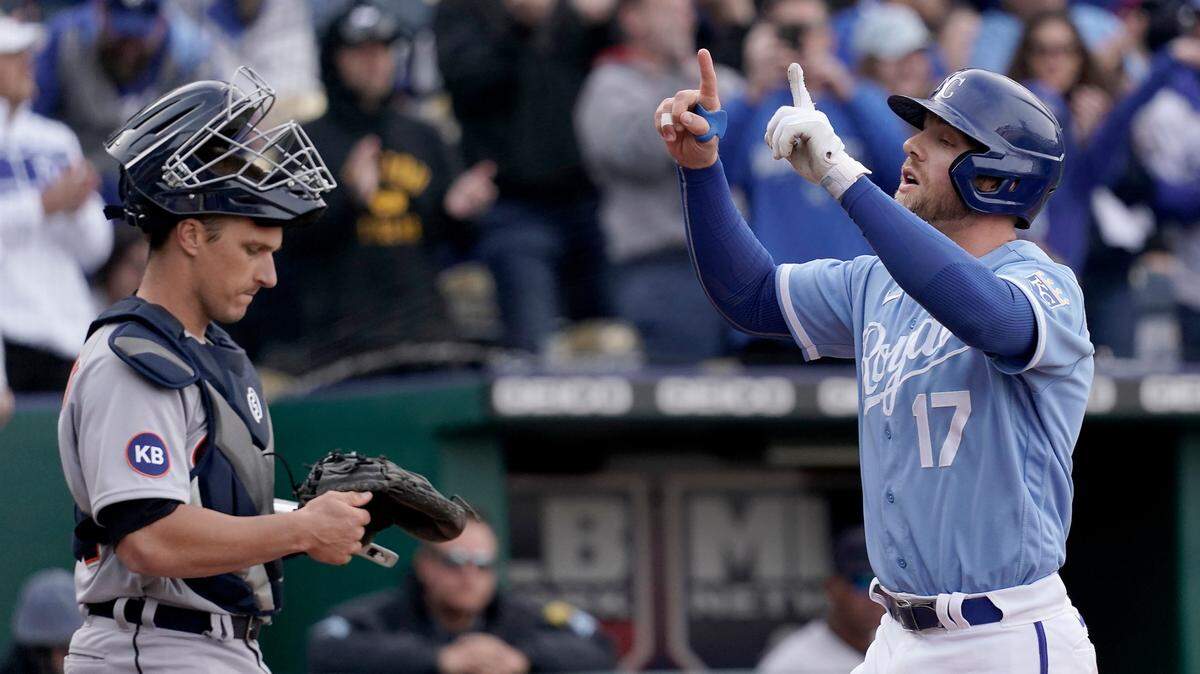 Kansas City Royals’ Hunter Dozier (16) crosses the plate past Detroit Tigers catcher Dustin Garneau after hitting a two-run home run during the sixth inning of a baseball game Saturday, April 16, 2022, in Kansas City, Mo. (AP Photo/Charlie Riedel)
