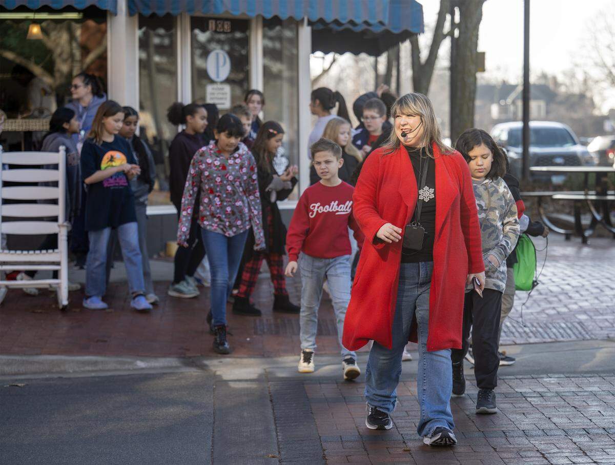 Music teacher Rachel Marlow, recently named the 2026 Kansas Teacher of the Year, led Central Elementary’s special chorus students across the street in downtown Olathe as they visited businesses to sing Christmas carols on Wednesday, Dec. 17, 2025.
