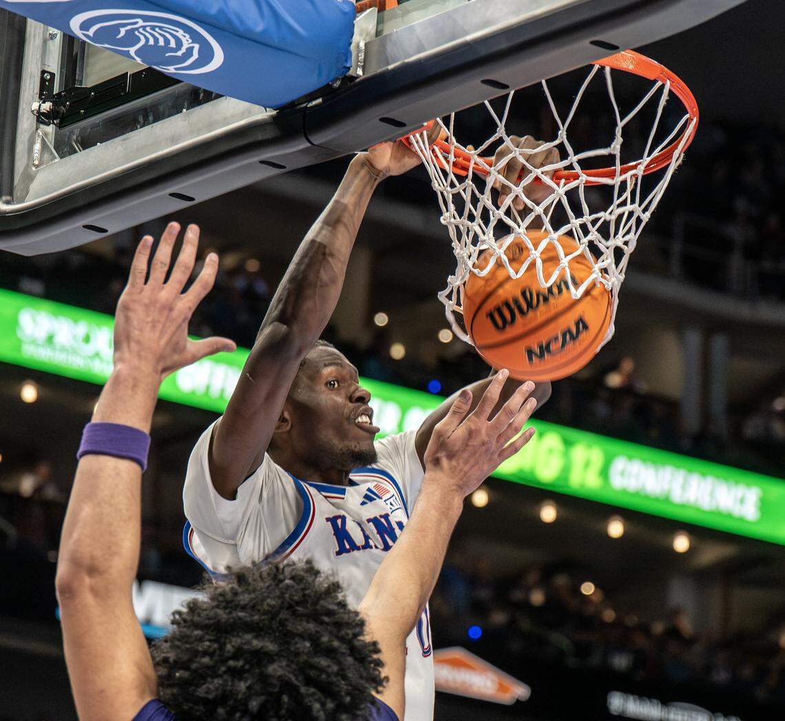 Kansas Jayhawks forward Flory Bidunga (40) makes a slam dunk over Texas Christian University Horned Frogs forward David Punch (15) during the second half of a Big 12 Men's Basketball Tournament game at T-Mobile Center on Thursday, March 12, 2026, in Kansas City.