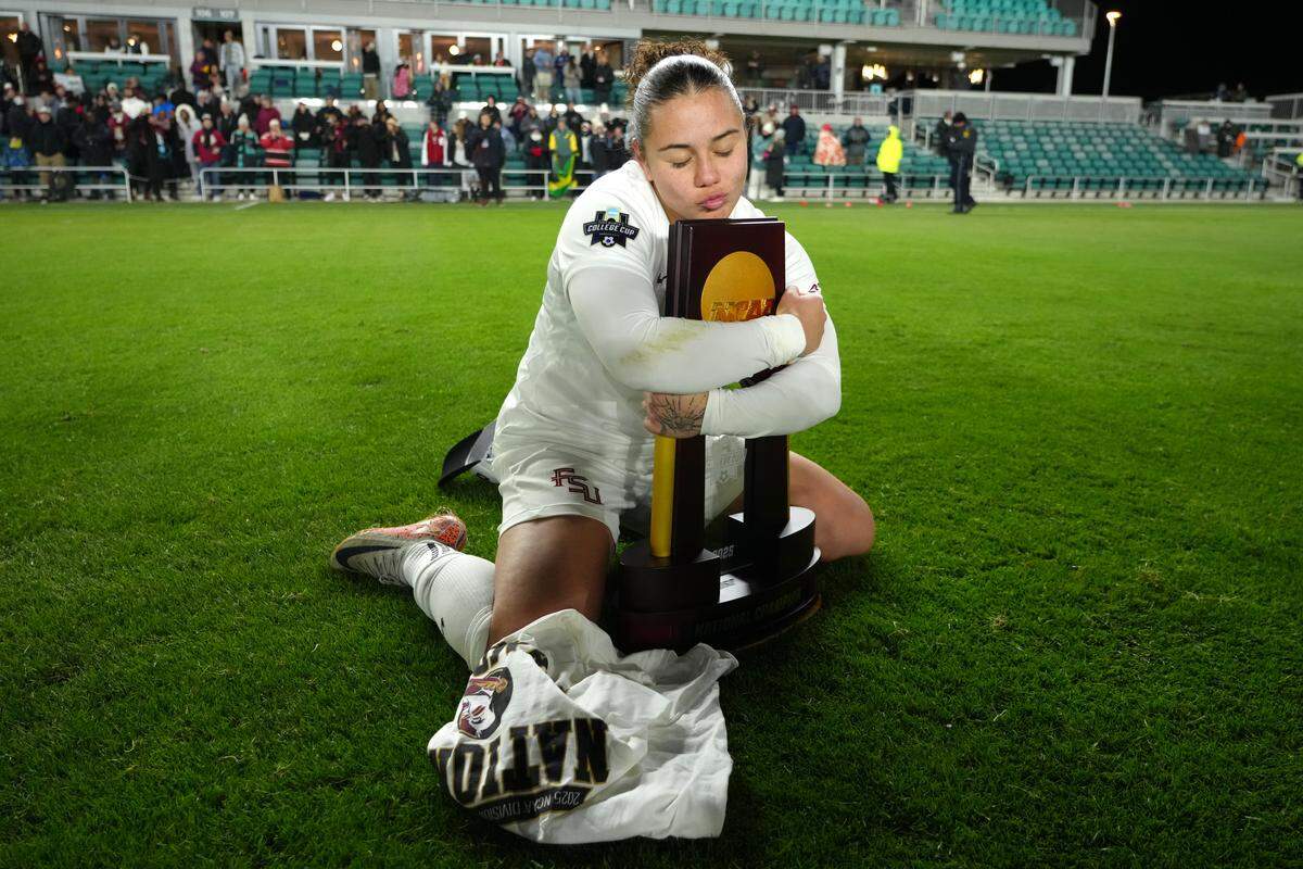 Midfielder Marianyela Jimenez #30 of the Florida State Seminoles celebrates with the NCAA Division I Women's Soccer Championship trophy after defeating the Stanford Cardinal at CPKC Stadium on December 8, 2025 in Kansas City.