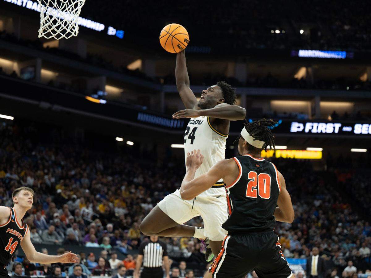 Missouri Tigers guard Kobe Brown (24) drives to the basket past Princeton Tigers forward Tosan Evbuomwan (20) during their second-round game in the NCAA Tournament at Golden 1 Center in Sacramento, Saturday, March 18, 2023.