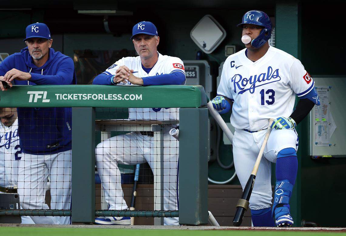 Salvador Perez #13 of the Kansas City Royals blows a bubble in the dugout while standing next to manager Matt Quatraro #33 during the game against the Baltimore Orioles at Kauffman Stadium on April 20, 2026 in Kansas City, Missouri.