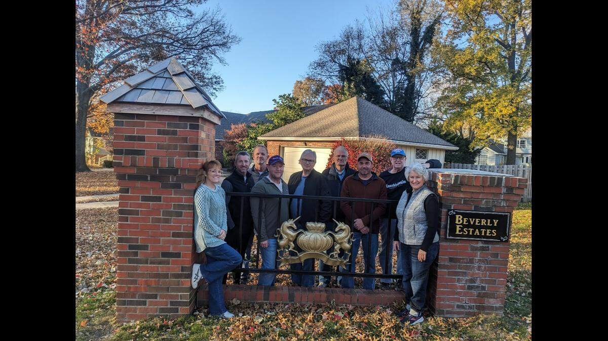 A group of volunteers who live in Beverly Estates worked for two years to restore the community’s signs. They included, from left, Liz Graham, Steven Meyer, Brian Curtis, Josh Engelbert, Mike McMahon, Stan Berry, Rob Walton, Rick Brown and Colette Panchot.