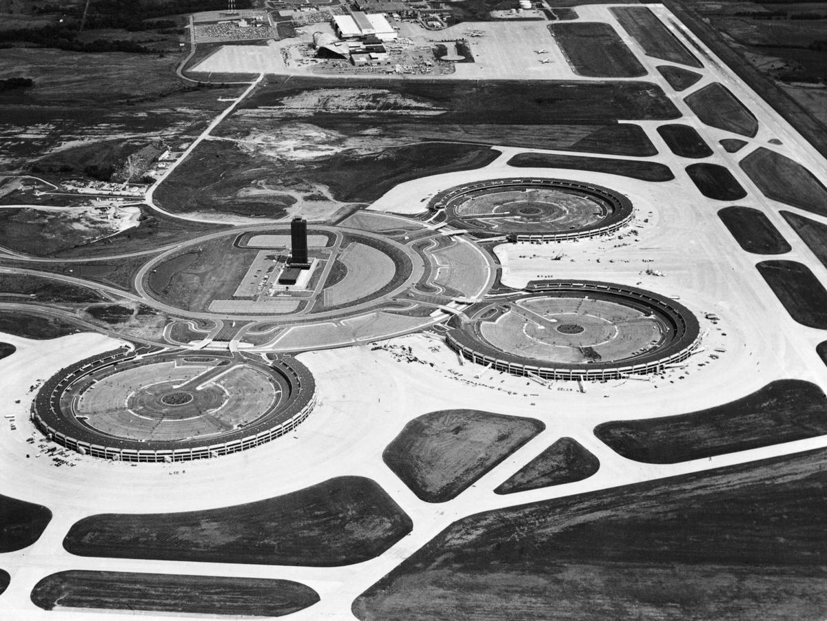 When Kansas City International Airport opened in 1972 the parking lots at the center of each of the semi-circular terminals were simple parking lot. Those lots were later replaced with multi-level parking garages.