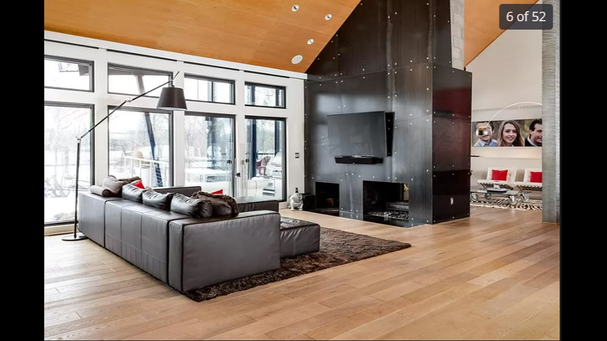 The floor-to-ceiling windows on the main level of the home at 14420 Mission Road in Leawood give the home natural sunlight in every area, including the living room.