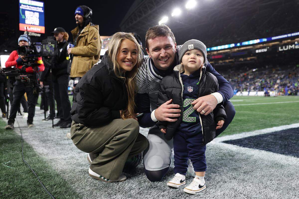 Drew Lock #2 of the Seattle Seahawks greets his family before the game against the Los Angeles Rams at Lumen Field on December 18, 2025 in Seattle, Washington.