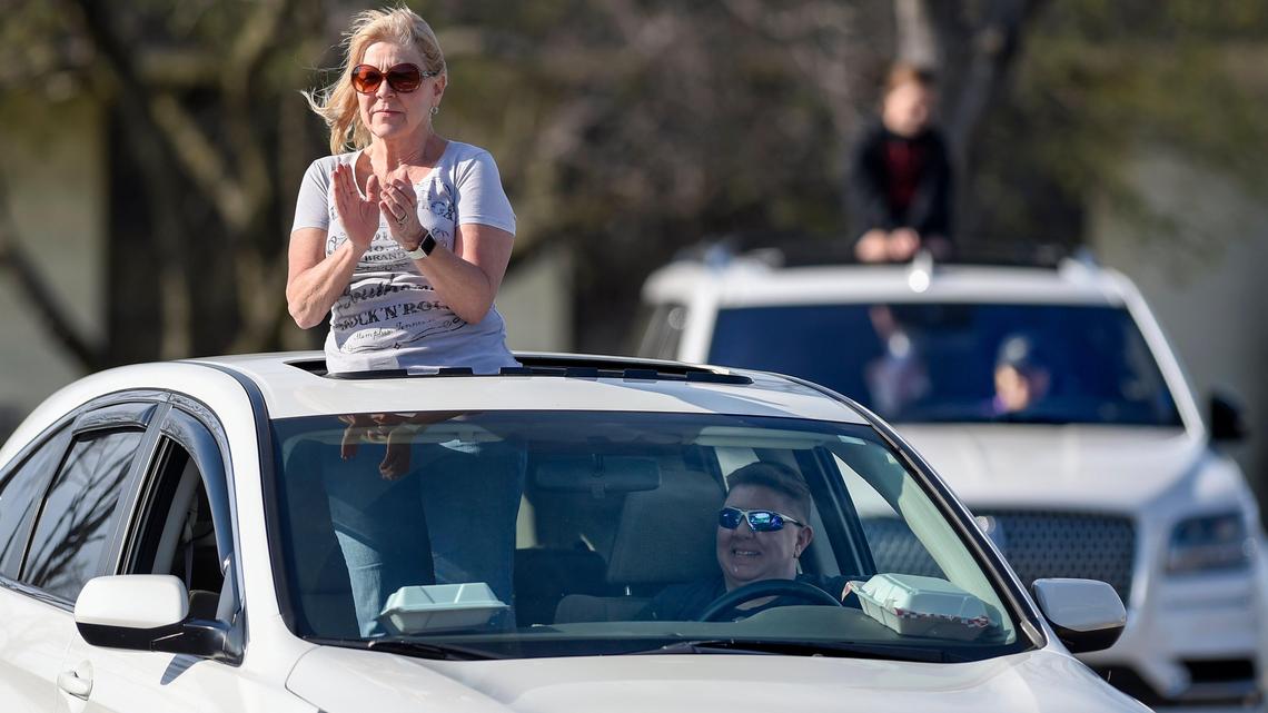 Barbara Redford dances in her car during a drive-in car concert with live music in the parking lot of Fireside BBQ & Bar on Wednesday, April 1, 2020, in Overland Park, Kansas. The restaurant is bringing people together for food, music and social distancing from their cars, which are spaced one parking spot apart. Redford, who said she misses live music during the stay at home orders, attended the concert with her daughter Heidi Henik.