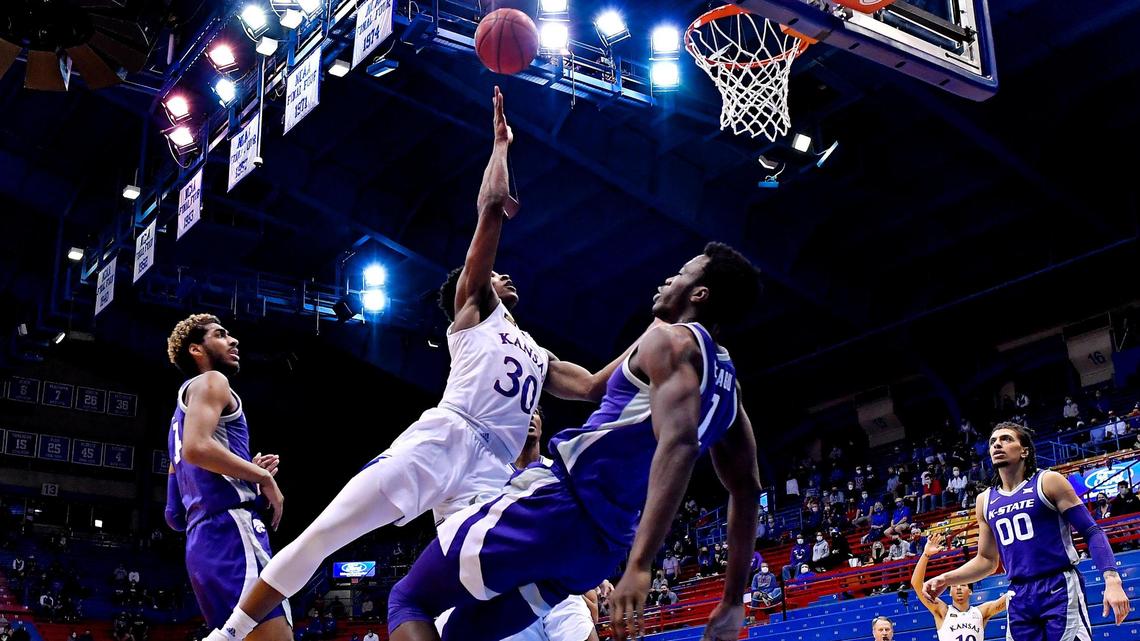 KU’s Ochai Agbaji scores over KSU’s Kaosi Ezeagu during the second half of Tuesday night’s Big 12 Conference game at Allen Fieldhouse. KU beat Kansas State, 74-51.