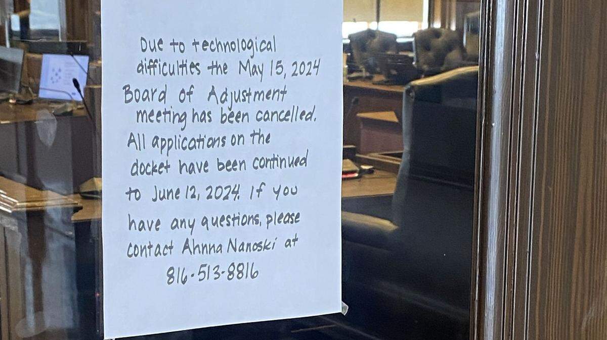 A sign on the door to the council chambers on the 26th floor of City Hall on Wednesday told visitors that business is not back to normal.