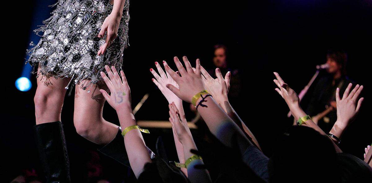 Fans reach out to try to touch Taylor Swift while she performed during her Fearless Tour show in 2010 in Kansas City.