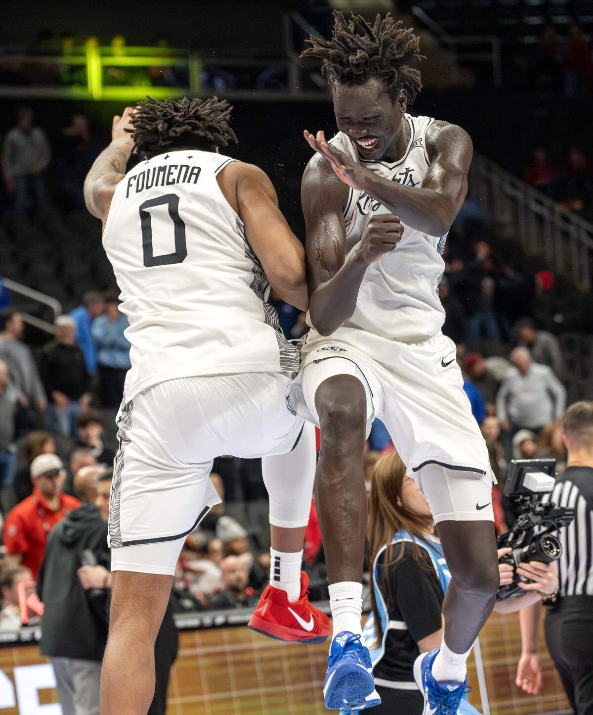 UCF centers Jeremy Foumena (0) and John Bol (7) celebrate after defeating Cincinnati 66-65 in overtime in a Big 12 Men's Basketball Tournament game at T-Mobile Center on Wednesday, March 11, 2026, in Kansas City