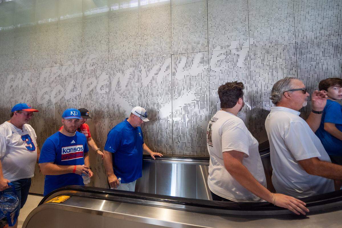 Fans ride an escalator inside David Booth Kansas Memorial Stadium prior to the Jayhawks game vs. the Fresno State Bulldogs on Saturday, Aug. 23, 2025, in Lawrence.