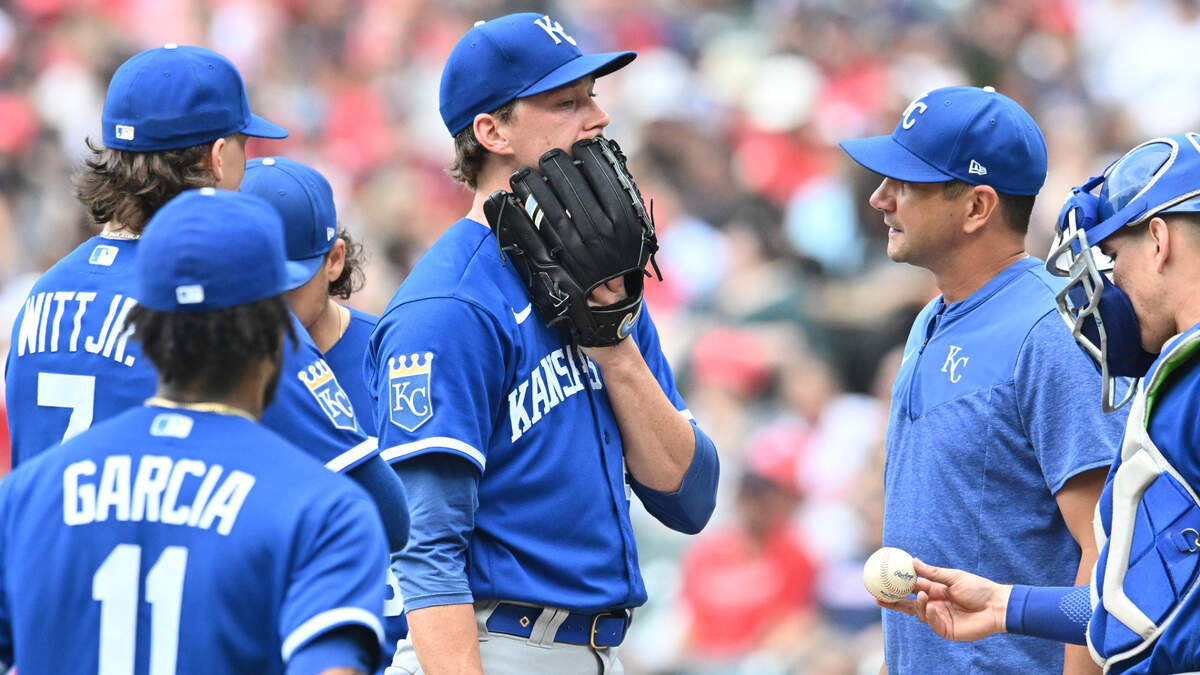 Kansas City Royals starting pitcher Brady Singer (51) talks with pitching coach Brian Sweeney (85) during the second inning against the Cleveland Guardians at Progressive Field on July 8, 2023.