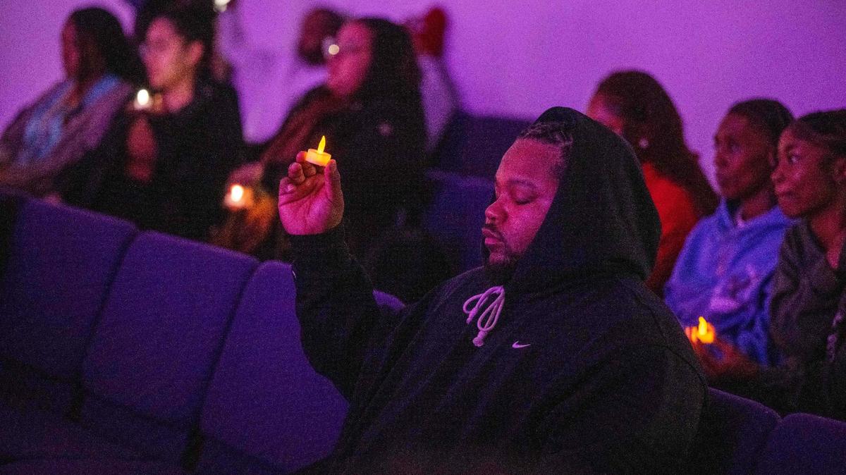 Matt Simpson holds a candle at a prayer vigil that was held on Monday, Dec. 30, 2024 at Great Metropolitan Church of Christ in Kansas City. Simpson lost his niece in a homicide.