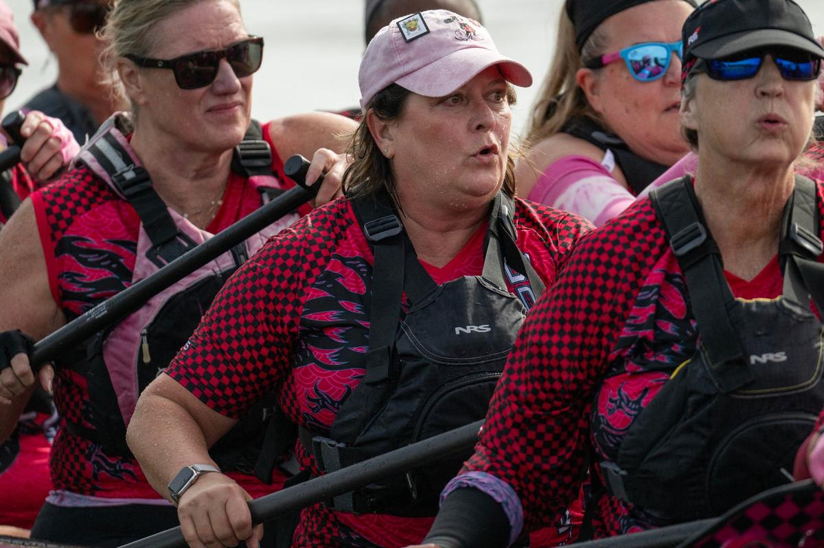 Crew members from Indy SurviveOars paddle in a qualifying race during the KC Dragon Boat Festival on Saturday, Sept. 28, 2024, at Shawnee Mission Park.