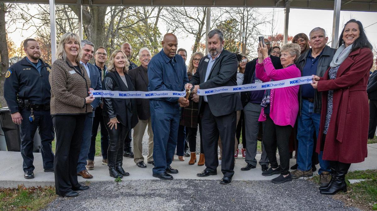 Kansas City, Kansas, Mayor Tyrone Garner, center, and Hillcrest Transitional Housing president and CEO, Tom Lally, cut a ribbon alongside community officials and Hillcrest associates to celebrate the opening of a new transitional housing project, Wednesday, Nov. 20, 2024, in Kansas City, Kansas.