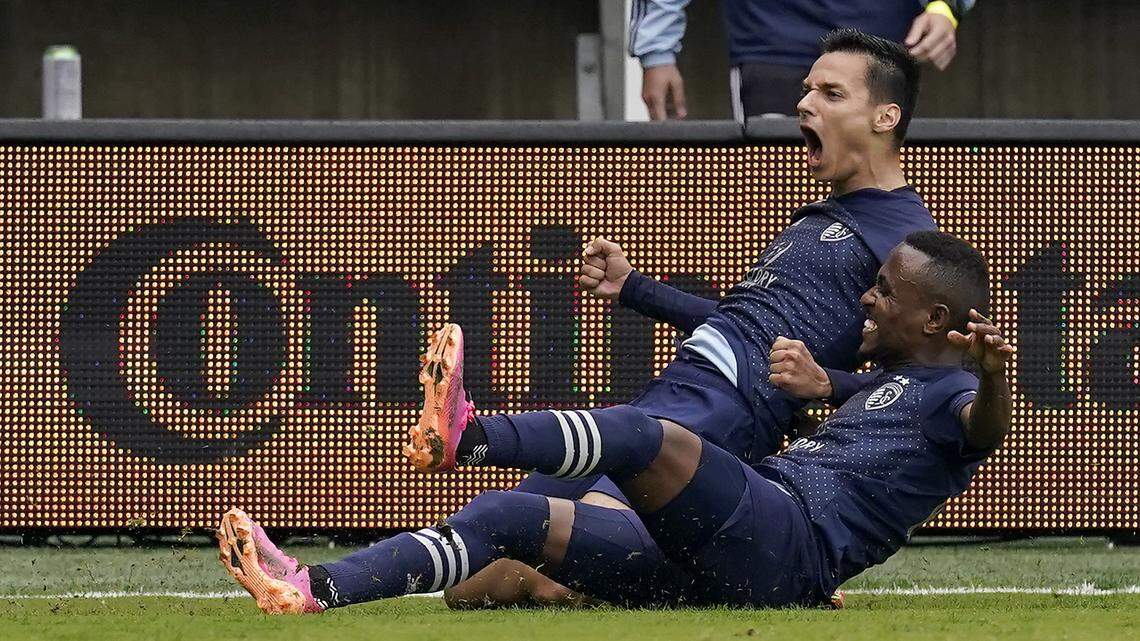 Sporting Kansas City forward Daniel Salloi, top, celebrates with midfielder Gadi Kinda after scoring a goal during the first half of an MLS soccer match against the Vancouver Whitecaps Sunday, May 16, 2021, in Kansas City, Kan. (AP Photo/Charlie Riedel)